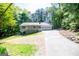 A front elevation shows the home's long driveway and a view of the surrounding trees at 6026 Belle Meade Ct, Villa Rica, GA 30180