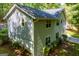 Back side of the house surrounded by mature trees and plants and featuring many windows for natural light at 6026 Belle Meade Ct, Villa Rica, GA 30180