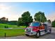 A view of a pristine fire engine with the American flag waving in a picturesque golf course community at 6026 Belle Meade Ct, Villa Rica, GA 30180