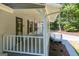 A view of the covered porch showing the house number, windows and the walkway to the two car garage at 6026 Belle Meade Ct, Villa Rica, GA 30180