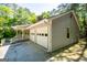 A corner of this charming home shows the two-car garage and covered porch at 6026 Belle Meade Ct, Villa Rica, GA 30180