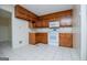 View of the kitchen showcasing wood cabinets and white appliances against neutral walls at 6026 Belle Meade Ct, Villa Rica, GA 30180