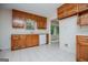 Traditional kitchen featuring wooden cabinets, white appliances, and tile flooring at 6026 Belle Meade Ct, Villa Rica, GA 30180
