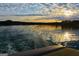 Stunning sunset over the lake, reflecting on the water's surface, creating a serene and peaceful atmosphere at 6026 Belle Meade Ct, Villa Rica, GA 30180