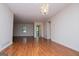 Bright living room with laminate floors, neutral walls, and a classic chandelier at 6026 Belle Meade Ct, Villa Rica, GA 30180