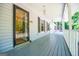 The spacious porch features vintage lighting, and a view of the trees and street at 6026 Belle Meade Ct, Villa Rica, GA 30180