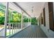 An expansive covered porch is ready for relaxing and enjoying the forest views at 6026 Belle Meade Ct, Villa Rica, GA 30180