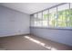 Enclosed sunroom featuring large screened windows and plush carpet flooring at 6026 Belle Meade Ct, Villa Rica, GA 30180