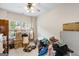 Bright bedroom with neutral carpet, ceiling fan, and natural light from a large window at 3206 Abbott Dr # 12, Powder Springs, GA 30127