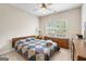 Cozy bedroom featuring a comfortable bed, window, and traditional wooden furniture at 3206 Abbott Dr # 12, Powder Springs, GA 30127