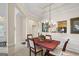 Dining room showcasing wainscoting, traditional chandelier, and view of the kitchen at 3206 Abbott Dr # 12, Powder Springs, GA 30127