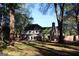 Expansive backyard featuring a brick house, lush greenery, and mature trees at 4786 Carlene Sw Way # Iv, Lilburn, GA 30047