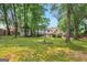 Expansive backyard featuring a gazebo, mature trees, and lush green grass at 4786 Carlene Sw Way # Iv, Lilburn, GA 30047