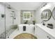 This bathroom showcases a modern tub, a large mirror, and a luxurious glass shower at 4786 Carlene Sw Way # Iv, Lilburn, GA 30047