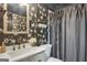 Chic bathroom with modern floral wallpaper, updated vanity, and elegant finishes at 4786 Carlene Sw Way # Iv, Lilburn, GA 30047