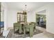 Elegant dining area featuring green upholstered chairs, area rug, and detailed moldings at 4786 Carlene Sw Way # Iv, Lilburn, GA 30047