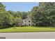 Stately brick home nestled among mature trees and a lush green lawn at 4786 Carlene Sw Way # Iv, Lilburn, GA 30047
