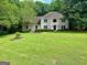 Charming two-story brick home with landscaped front yard and lush green lawn at 4786 Carlene Sw Way # Iv, Lilburn, GA 30047