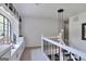 Upstairs hallway features built in cabinets and shelves with a modern, decorative pendant light at 4786 Carlene Sw Way # Iv, Lilburn, GA 30047