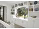 Bright hallway features custom built-in shelving, cabinets, and a cozy window nook perfect for reading at 4786 Carlene Sw Way # Iv, Lilburn, GA 30047