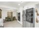 Open kitchen with stainless steel refrigerator and oven, flowing into dining area with modern chairs at 4786 Carlene Sw Way # Iv, Lilburn, GA 30047