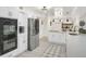 Bright kitchen with white cabinets, stainless steel appliances, and modern lighting fixtures at 4786 Carlene Sw Way # Iv, Lilburn, GA 30047