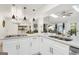 Modern kitchen with white cabinets, quartz countertops, and an open layout to dining and living areas at 4786 Carlene Sw Way # Iv, Lilburn, GA 30047