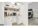Charming kitchenette featuring tiled backsplash, white cabinets, and a beverage station at 4786 Carlene Sw Way # Iv, Lilburn, GA 30047