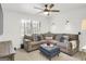 Relaxing living room features a plush sectional, ottoman, a ceiling fan, and soft natural light at 4786 Carlene Sw Way # Iv, Lilburn, GA 30047