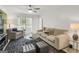 Comfortable living room with neutral furniture, plantation shutters, and decorative lighting at 4786 Carlene Sw Way # Iv, Lilburn, GA 30047