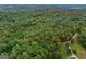 Aerial view of a vast, forested property outlined in red, highlighting the expanse of the woodland area at 6605 Old White Mill Rd, Fairburn, GA 30213
