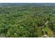 Sprawling woodland viewed from above, with a gravel road winding through the trees at 6605 Old White Mill Rd, Fairburn, GA 30213