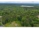 Overhead aerial view showcases a serene landscape with lush trees, a private home, and a beautiful countryside setting at 6605 Old White Mill Rd, Fairburn, GA 30213