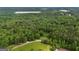 Sprawling aerial perspective of the expansive landscape, with a blend of lush greenery and natural terrain at 6605 Old White Mill Rd, Fairburn, GA 30213