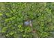 An aerial view displays the home nestled amidst a verdant forest, offering both privacy and natural beauty at 6605 Old White Mill Rd, Fairburn, GA 30213