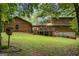 Back exterior showing large deck with umbrella and basement access at 6605 Old White Mill Rd, Fairburn, GA 30213