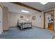 Finished basement bedroom with blue carpet, exposed beam, and neutral walls at 6605 Old White Mill Rd, Fairburn, GA 30213