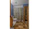 A cozy bathroom featuring a shower with a themed curtain and a colorful patterned rug at 6605 Old White Mill Rd, Fairburn, GA 30213