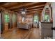 Comfortable bedroom with wood walls, soft lighting, dresser, and cozy bedding, offering a relaxing retreat at 6605 Old White Mill Rd, Fairburn, GA 30213