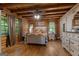 Comfortable bedroom with wood walls, soft lighting, dresser, and cozy bedding, offering a relaxing retreat at 6605 Old White Mill Rd, Fairburn, GA 30213