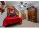 Sports themed bedroom with a wooden accent wall, red bedding, and Georgia Bulldogs decor at 6605 Old White Mill Rd, Fairburn, GA 30213