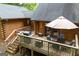 Spacious outdoor deck with a grill, dining set, and lounge chairs, perfect for entertaining and enjoying outdoor meals at 6605 Old White Mill Rd, Fairburn, GA 30213