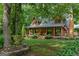 Log cabin style home with covered front porch at 6605 Old White Mill Rd, Fairburn, GA 30213