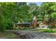 Log cabin style home with covered front porch and a detached two-car garage at 6605 Old White Mill Rd, Fairburn, GA 30213