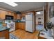 Functional kitchen featuring wooden cabinets, standard appliances, and a view of the connecting rooms at 6605 Old White Mill Rd, Fairburn, GA 30213