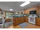 Functional kitchen features wooden cabinets, a breakfast bar, and a cozy breakfast nook at 6605 Old White Mill Rd, Fairburn, GA 30213