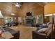 Spacious living room with vaulted ceilings, a stone fireplace, and log walls, creating a cozy and inviting atmosphere at 6605 Old White Mill Rd, Fairburn, GA 30213