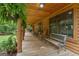 Inviting covered porch with comfortable seating and hanging plants, offering a serene outdoor space to relax and enjoy the view at 6605 Old White Mill Rd, Fairburn, GA 30213