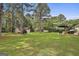 Expansive backyard with mature trees, patio area, and detached garage, perfect for outdoor activities at 150 Whitney Way, Fayetteville, GA 30214