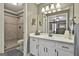 Bright bathroom with white cabinets, a large mirror, and a tiled walk-in shower at 150 Whitney Way, Fayetteville, GA 30214